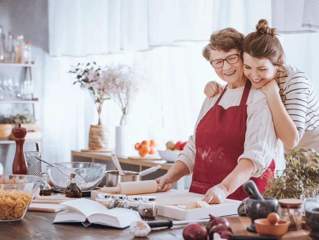 A caregiver and loved one preparing a meal together at home